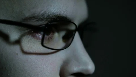 The man's face appears out of the darkness. Depression. Isolated. Paranoic Stock Footage 88950056