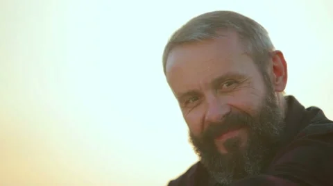 The man's face with a beard in nature.Portrait of a man hipster closeup. Stock Footage 54490976