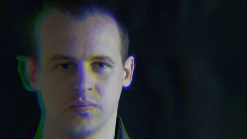 The man's face, distorted with random characters. Concept: a glitch in the Stock Footage 76550085