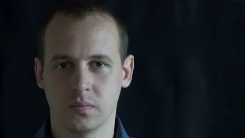 The man's face, distorted with random characters. Concept: a glitch in the Stock Footage 76561924