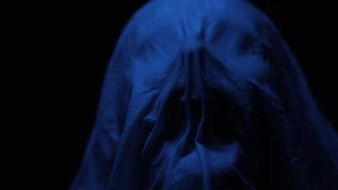 A mans face is eerily wrapped in a soaked cloth Stock Footage 312473840