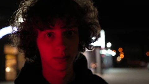 Man's face illuminated of multicolor side light outdoors at night, 4k 3 Video stock 95624725