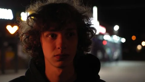 Man's face illuminated of multicolor side light outdoors at night, 4k 1 Видео 95624929