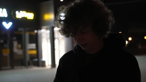 Man's face illuminated of strobe light outdoors at night, 4k 2 Video stock 95624592