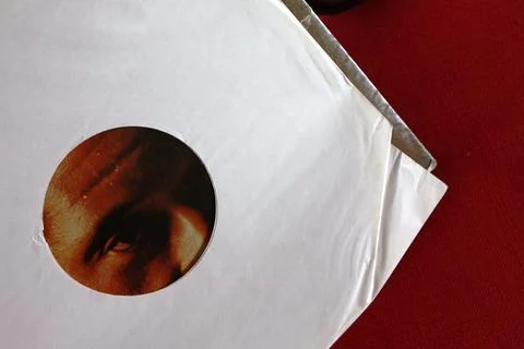 Man’s face looking through record LP sleeve Stock Photos