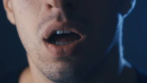 Man's face screaming in fear with hands covering mouth, extreme close-up Stock Footage 106599885