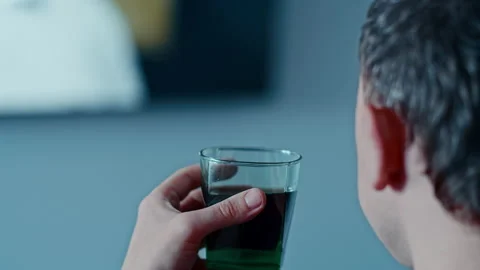 Man's face from the side, drinking a drink and watching TV Stock Footage 155467071