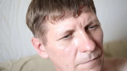 Man's face smokes a hookah lets smoke through his nose Stock Footage 100854469