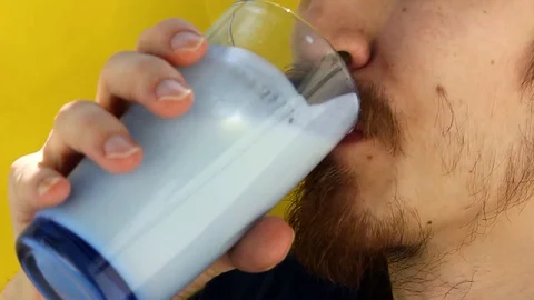 Man's face with thick white milk covering upper lip. June 1 World Milk Day Stock Footage 130126175