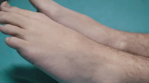 Mans feet on turquoise background Stock Footage 312009463
