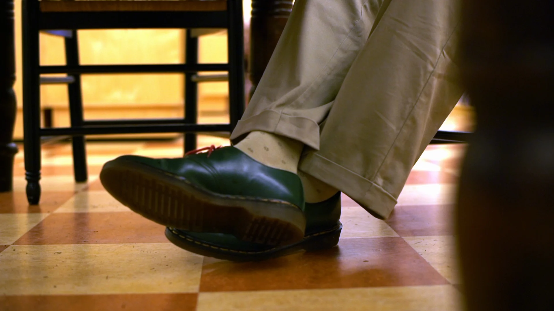 Mans feet under a table.