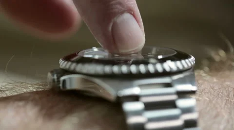 Man's finger impatiently taps his generic diver-style wristwatch. Video stock 55446341
