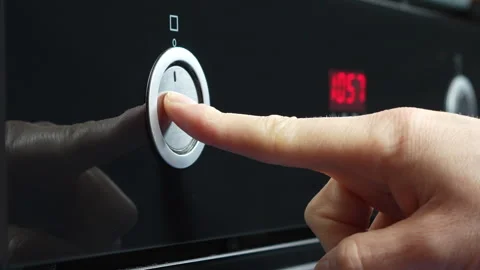 A man's finger presses the button of a microwave oven to open it. Stock Footage 307553423