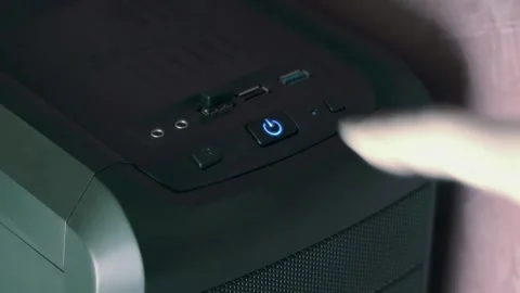 A man's finger presses the computer's system unit power button, the icon lights  Stock Footage 287952969