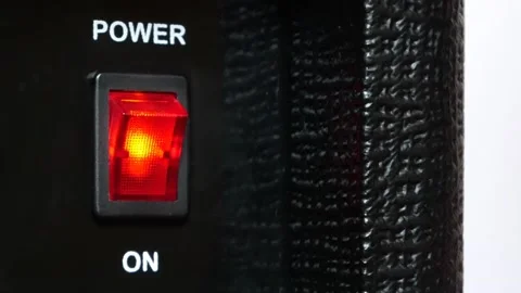 A mans finger presses the power button on the black panel close-up Stock Footage 145919581