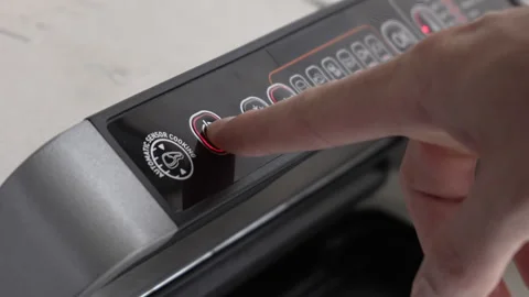 A man's finger presses the power button on a home electric grill to turn it on Stock Footage 246080958