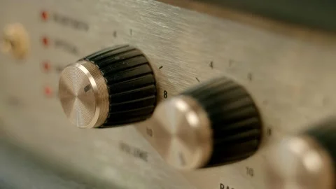 A man's finger presses the on off switch, adjusting the volume Stock Footage 297759895