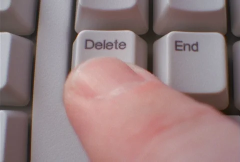 A man's finger pressing "delete" key on computer keyboard, close-up Stock Footage 86882666