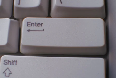 A man's finger pressing "enter" key on computer keyboard, close-up Stock Footage 86882768