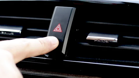 Man's finger is pressing Hazard warning lights in the car Video stock 165333837