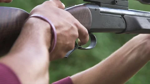 Man's finger pulls trigger, fires gun Video stock 248846375
