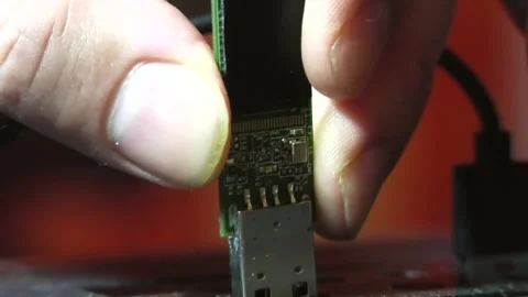 A man's fingers inserting a flash drive into a USB and pulling it back out Video stock 346881983