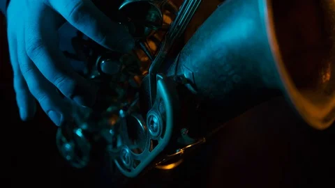 Man's fingers playing on the saxophone. Close up. Black background Video stock 127053258