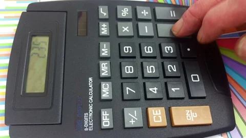 Mans fingers using a large button calculator Stock Footage 78167064