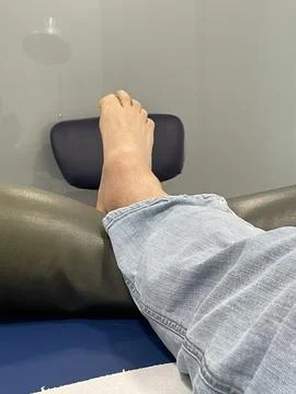 Man's foot moving with difficulty due to swollen ankle malformation. Tumefaction Stock Photos