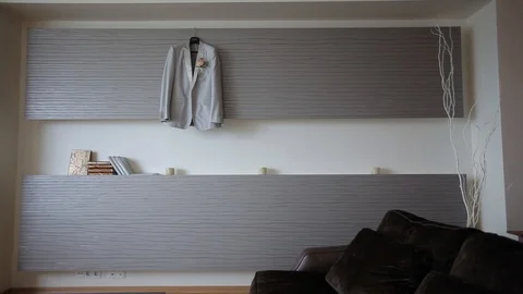 A man's glack jacket hanging in the bedroom hangs on a hanger before the groom's Stock Footage 95045966