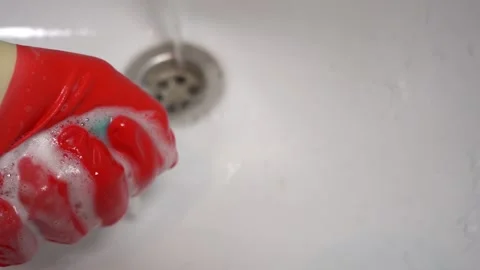 A man's gloved hand washes the sink. Close-up Stock Footage 168364212