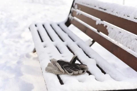 Mans gloves on the winter bench Stock Photos