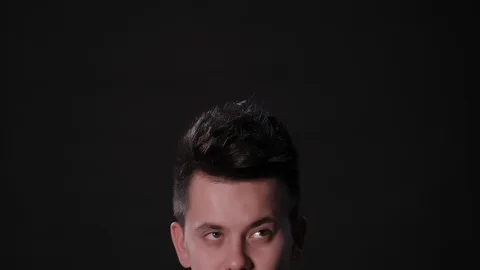 Man's Half Face Against a Black Background 스톡 동영상 87310122