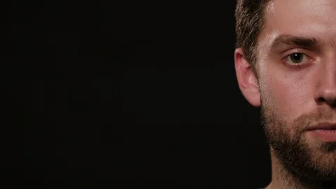 Man's Half Face Against a Black Background 스톡 동영상 88453023