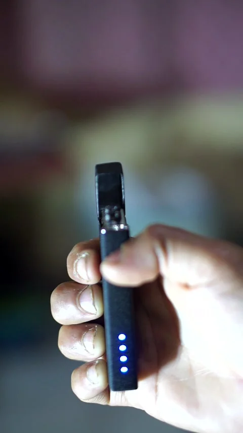 A man’s hand activating an electric plasma lighter with glowing sparks Video stock 327325325