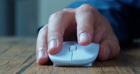 Man's hand actively uses a computer mouse while working at a computer, clicks Stock Footage 230259914