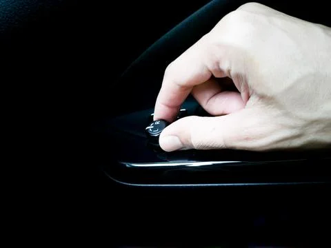 The man's hand is adjusting the side mirror. Stock Photos