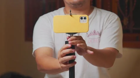 Man's Hand Adjusting Smartphone Tripod Mount Stock Footage 333317683