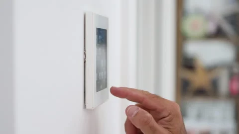Man's hand adjusting the temperature of the house on a home automation screen. Stock Footage 220033165