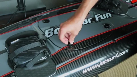 Mans hand adjusts knobs at board for surf on water jet 動画素材 74453376