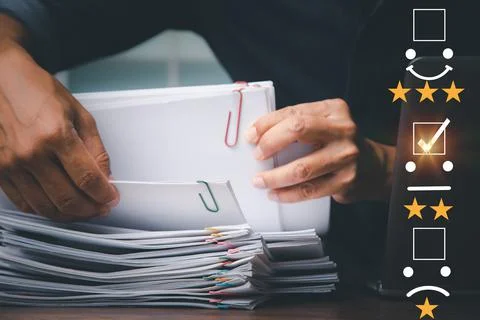 Man's hand analyzing documents papers questionnaire and combining the satisfa Stock Photos