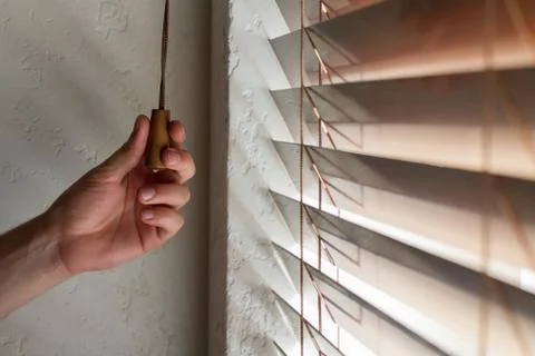 Man's hand and blinds Stock Photos