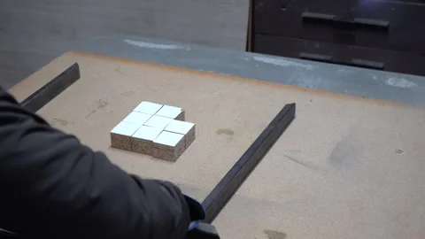 A man's hand assembles rectangular steel tubes into a jig Stock Footage 302302778
