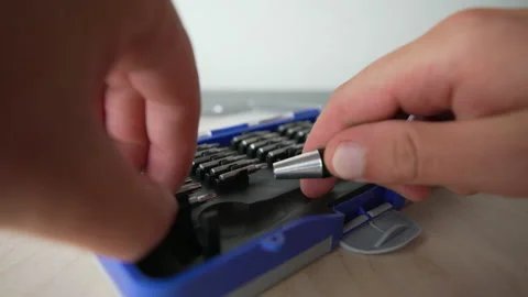 Mans hand assembling screwdriver set Stock Footage 158666474