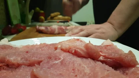 Man's hand beats raw meat on a wooden Stock Footage 86700223
