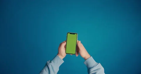 A man's hand in a blue sleeve scrolls the tape on the smartphone screen Stock Footage 149742884