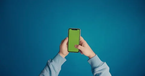 A man's hand in a blue sleeve scrolls the tape on the smartphone screen Stock Footage 149743400