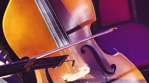 A man's hand with a bow is driving on cello strings. Close-up symphony concert Stock Footage 259933184