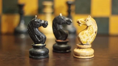 THE MAN'S HAND BREAKS THE WHITE CHESS KNIGHT Stock Footage 74884373