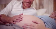 Man's Hand Caringly Touching His Wife's Pregnant Belly Stock Footage
